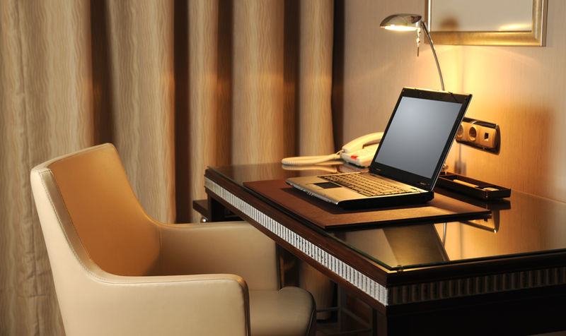 Desk with a laptop in a furnished room
